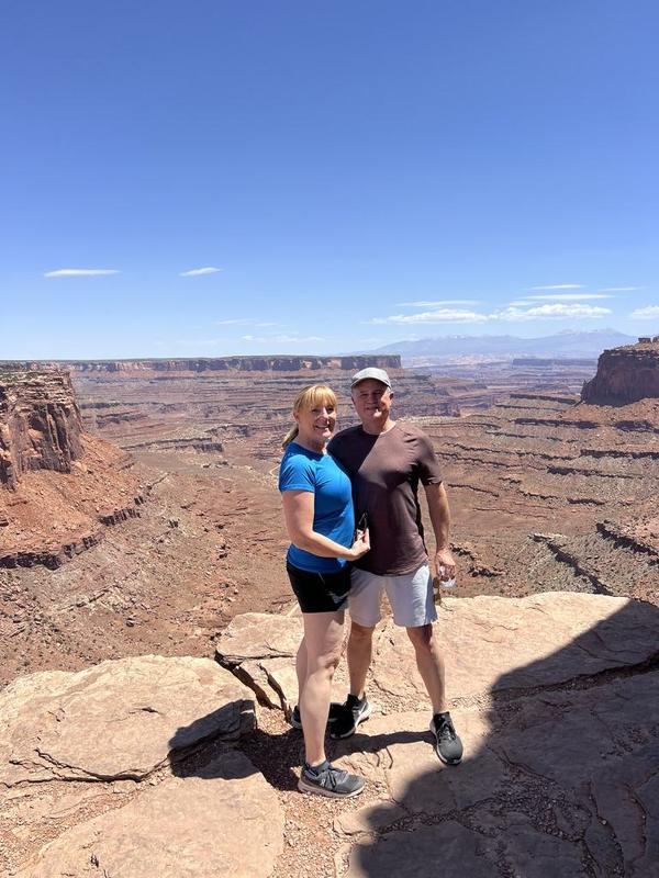 Mark and Lisa Marie Boyd on a red-rock canyon overlook under a big blue sky