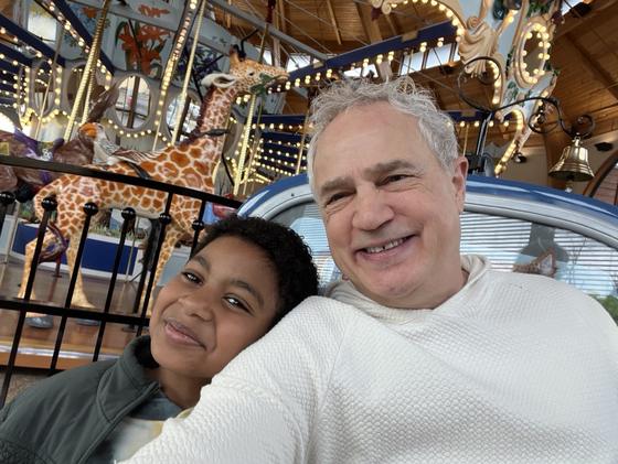 Selfie of Mark Boyd with a grandson at a carousel