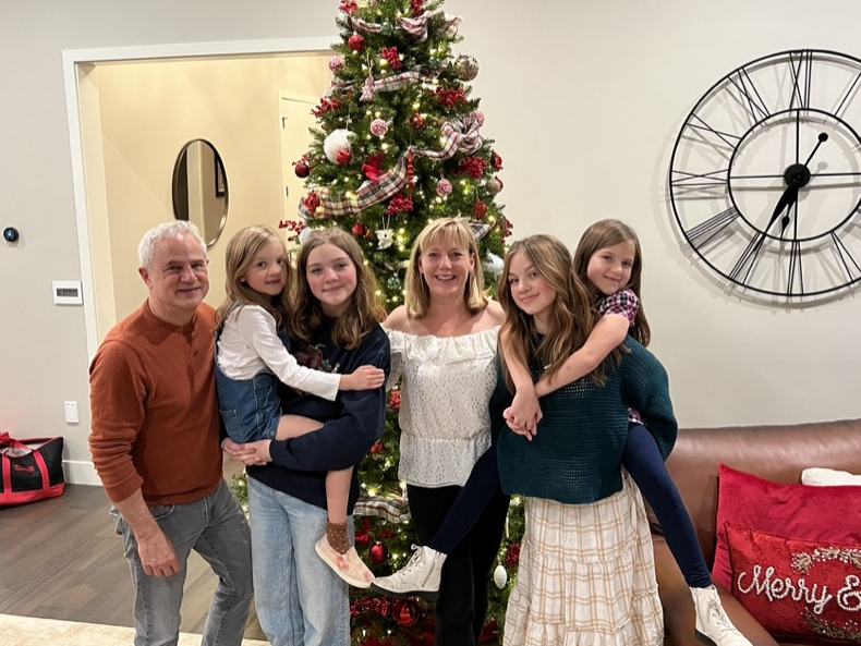 Mark and Lisa Marie Boyd with four granddaughters in front of a Christmas tree