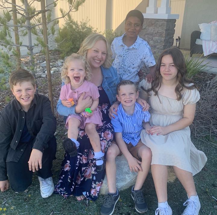 Mark's daughter Dr. Crystal Alstot with five grandchildren in a backyard