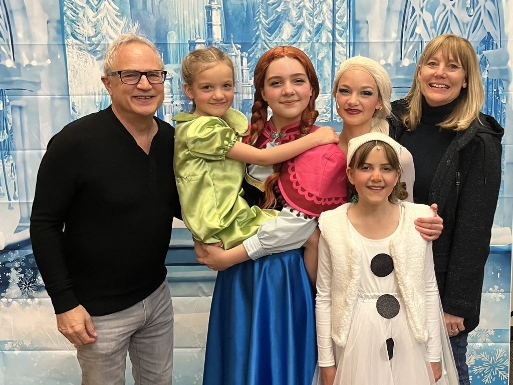 Mark and Lisa Marie Boyd with their granddaughters in costume after a production of Frozen
