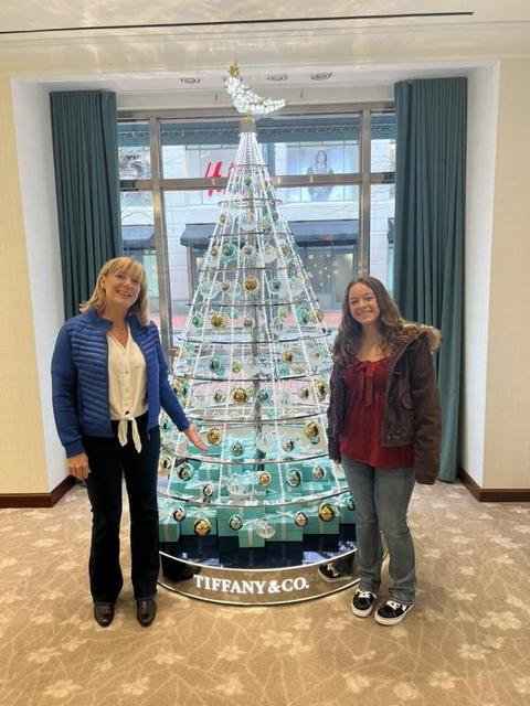 Lisa Marie Boyd and her granddaughter beside a Tiffany & Co. holiday tree