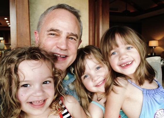 Mark Boyd in a selfie with three smiling young granddaughters