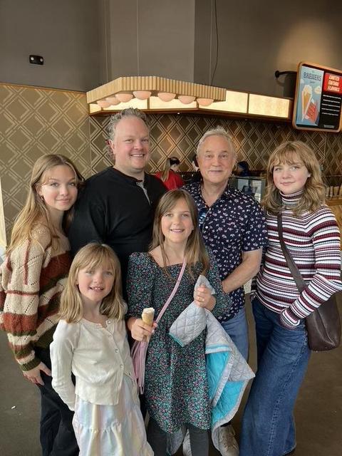 Mark Boyd with a family member and four granddaughters at an ice cream shop