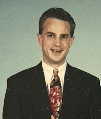 Mark Boyd in 1987, in a dark suit and patterned tie