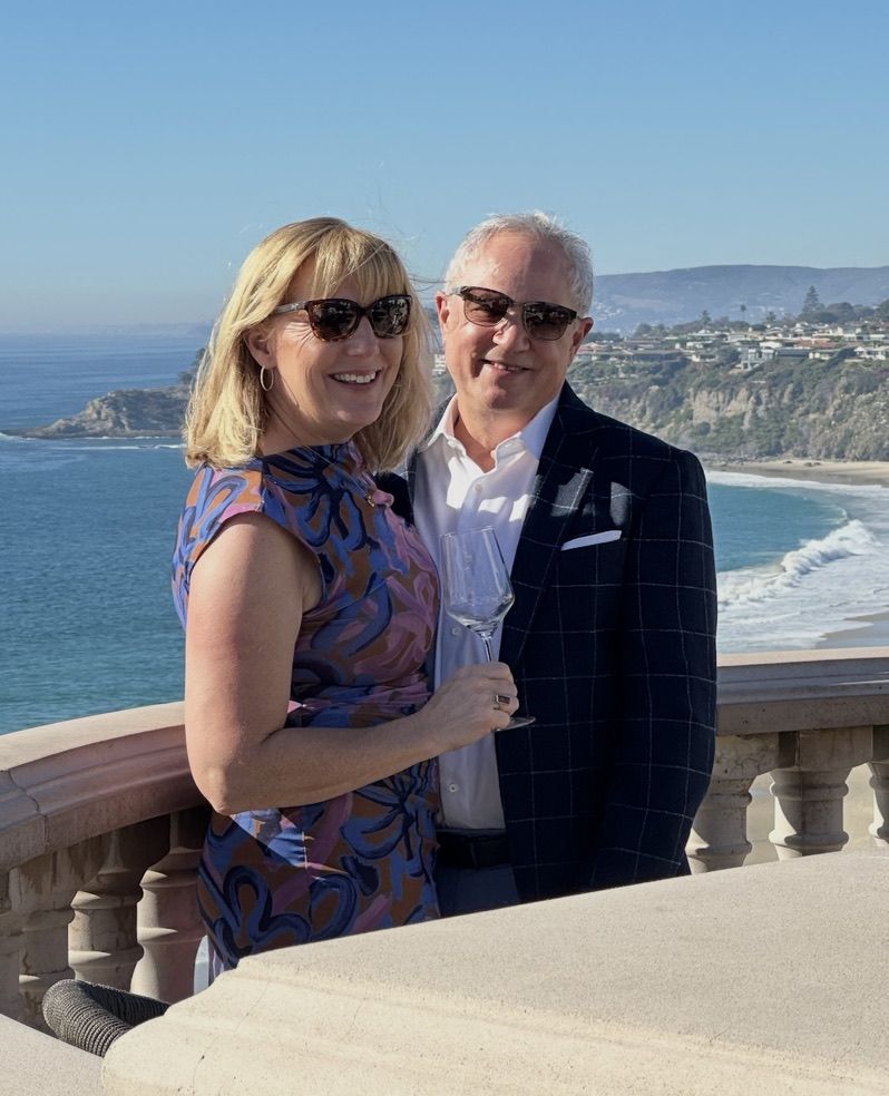 Mark and Lisa Marie Boyd, dressed up, on an ocean-view terrace in Laguna Beach, California