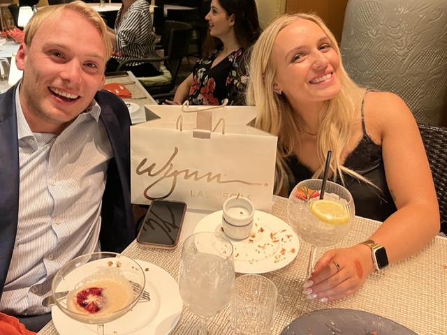 Matt and Emily smiling at dinner at Wynn Las Vegas