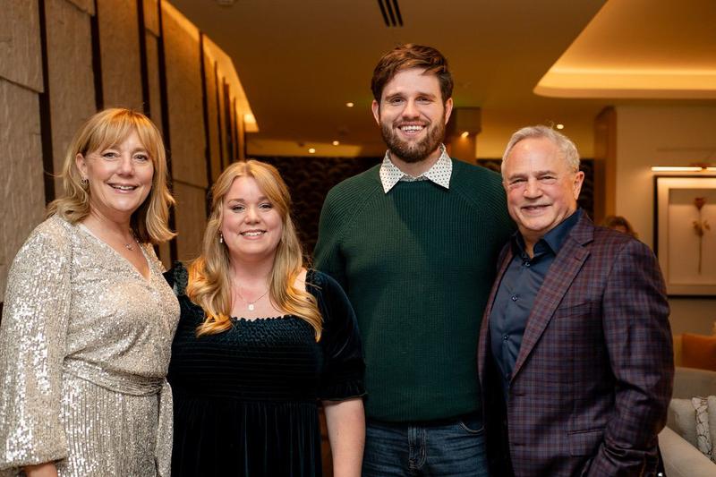 Mark Boyd in a plaid blazer at a formal event with Lisa Marie, Miranda and Sean